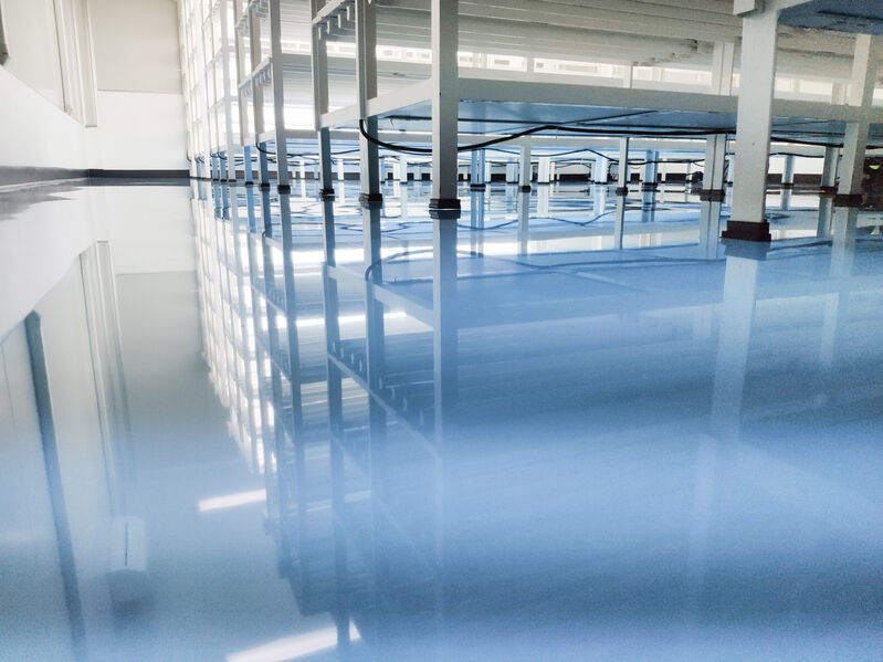 a cable under rack legs at sea blue epoxy floor. (Industrial epo